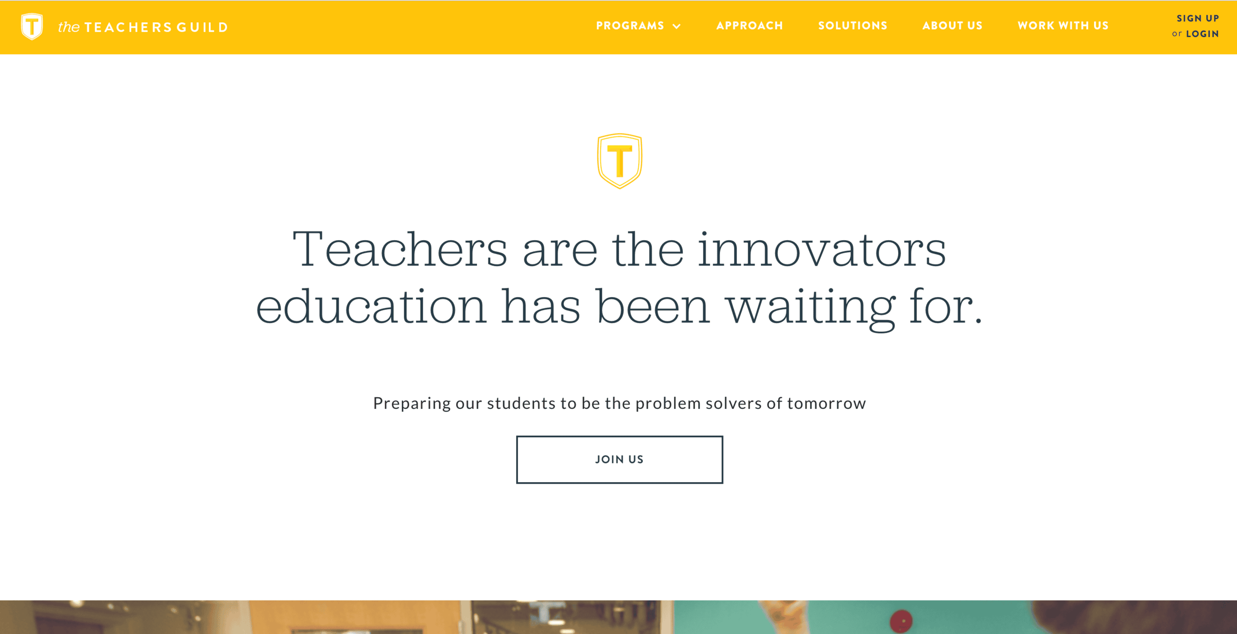 The Teachers Guild logo featuring a golden shield with the letter "T" in yellow on white background.