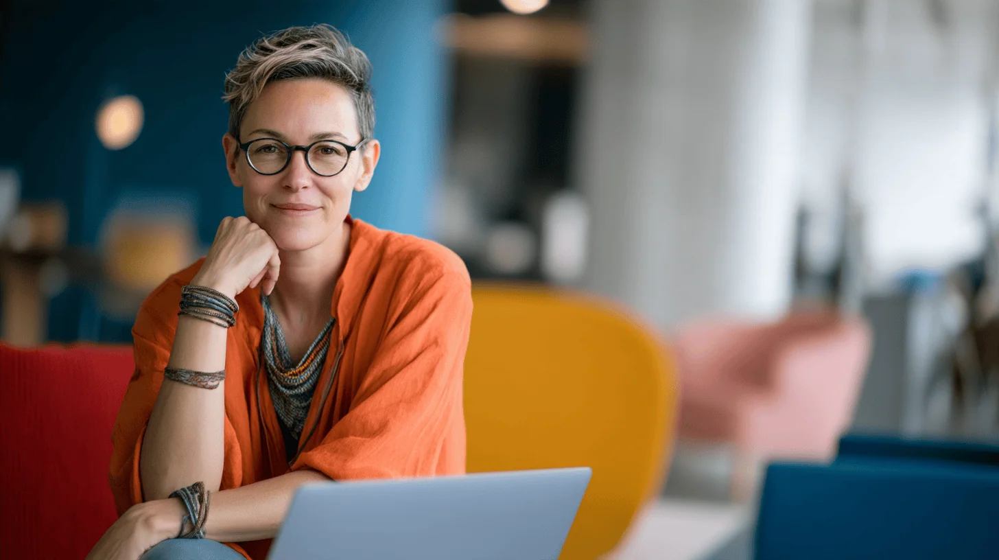 Smiling woman with laptop in cafe