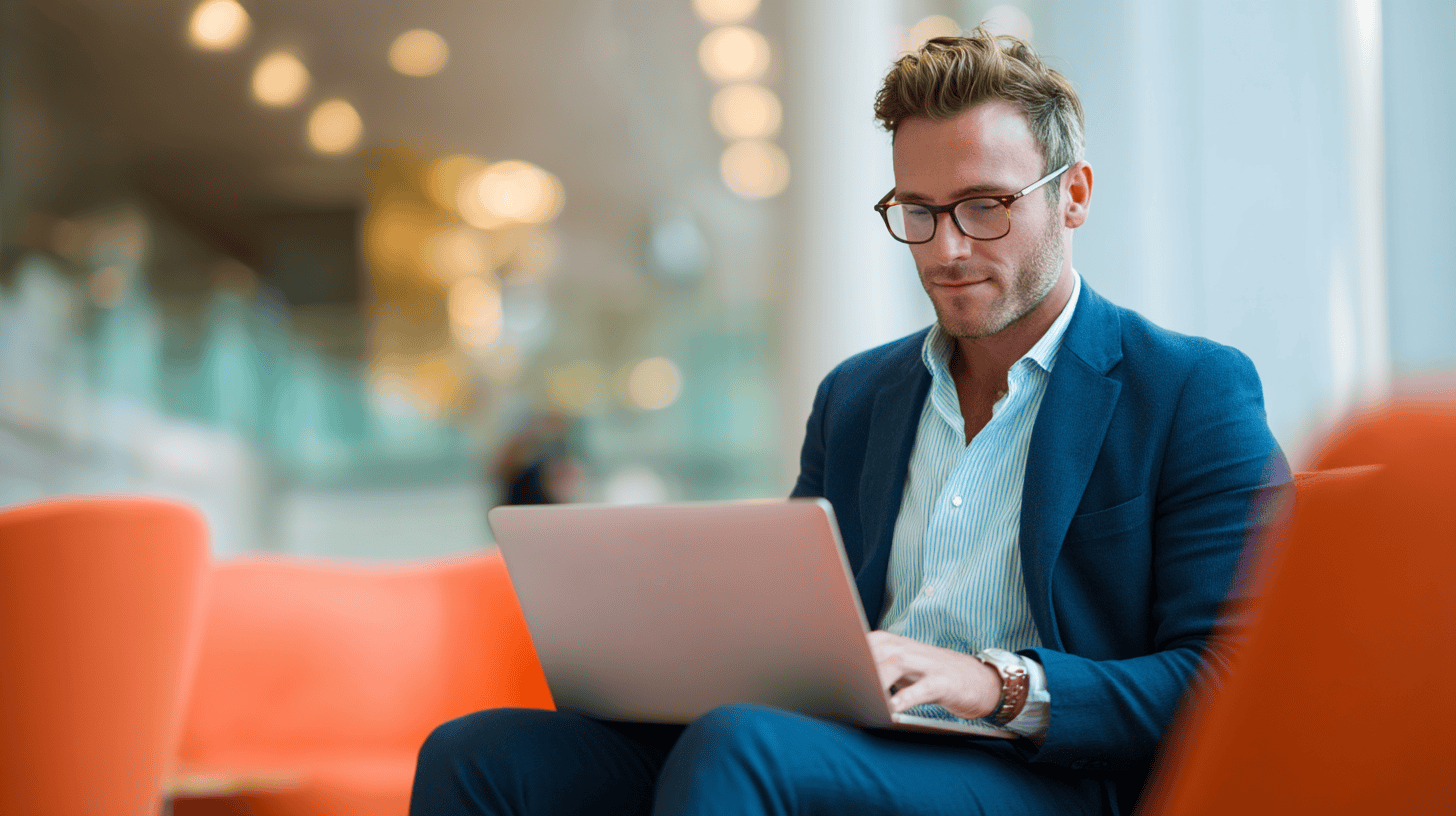Man working on laptop in cafe.