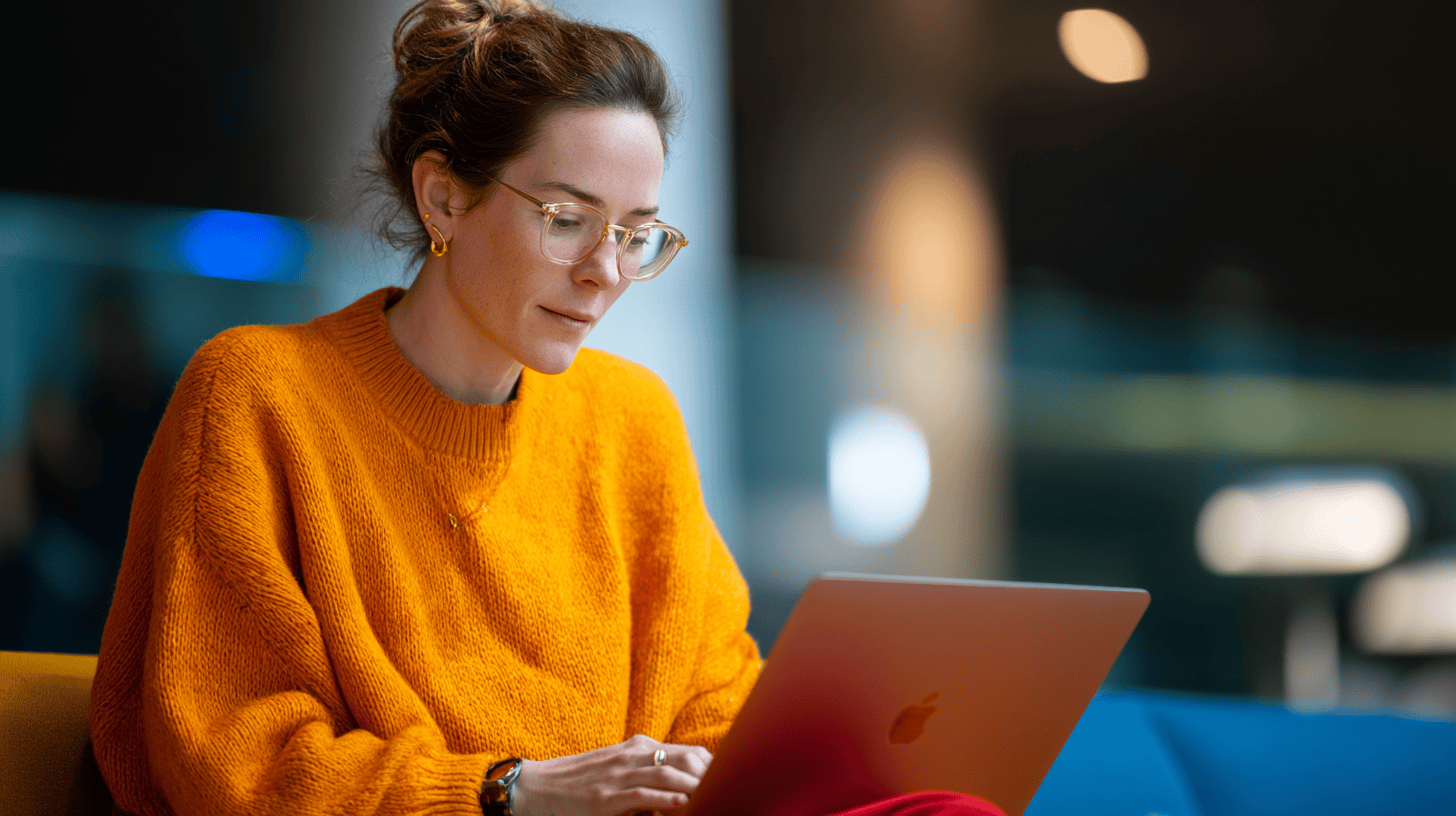 A marketing executive working on a laptop to design and manage large-scale account-based marketing campaigns for global clients.
