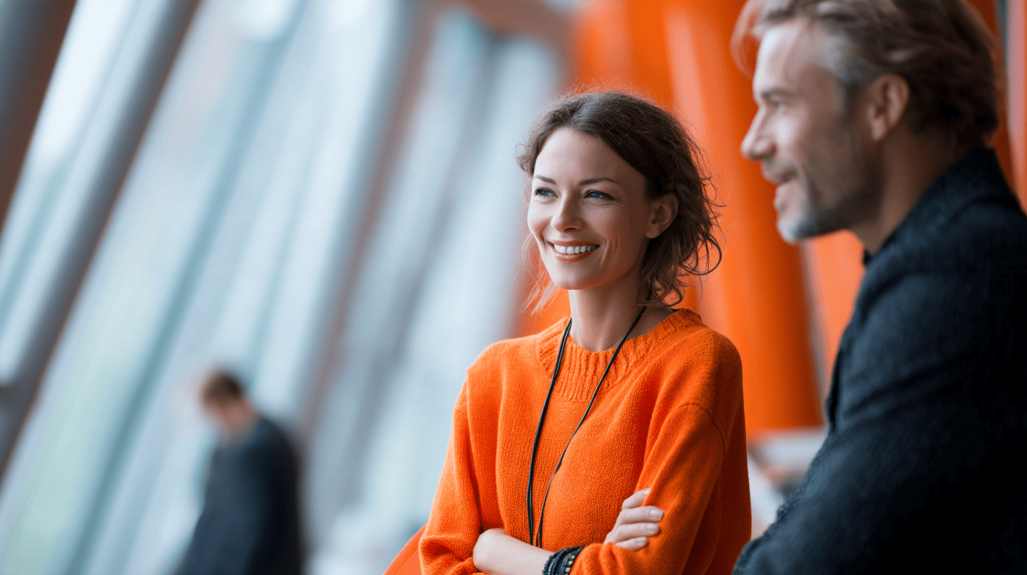 Two people smiling in modern setting.