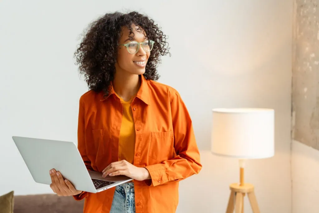 a woman holding a laptop