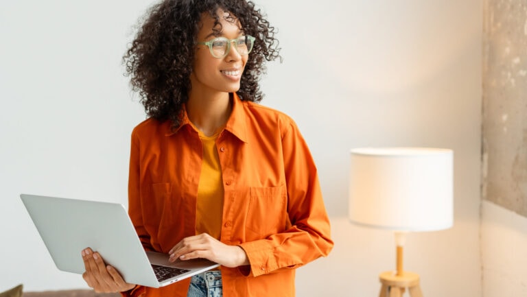 a woman holding a laptop