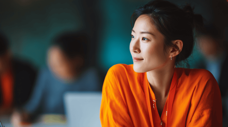 Person in orange shirt, blurred background.