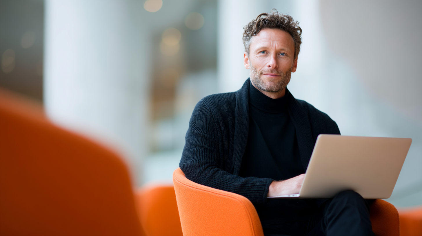 Man working on laptop in modern setting.