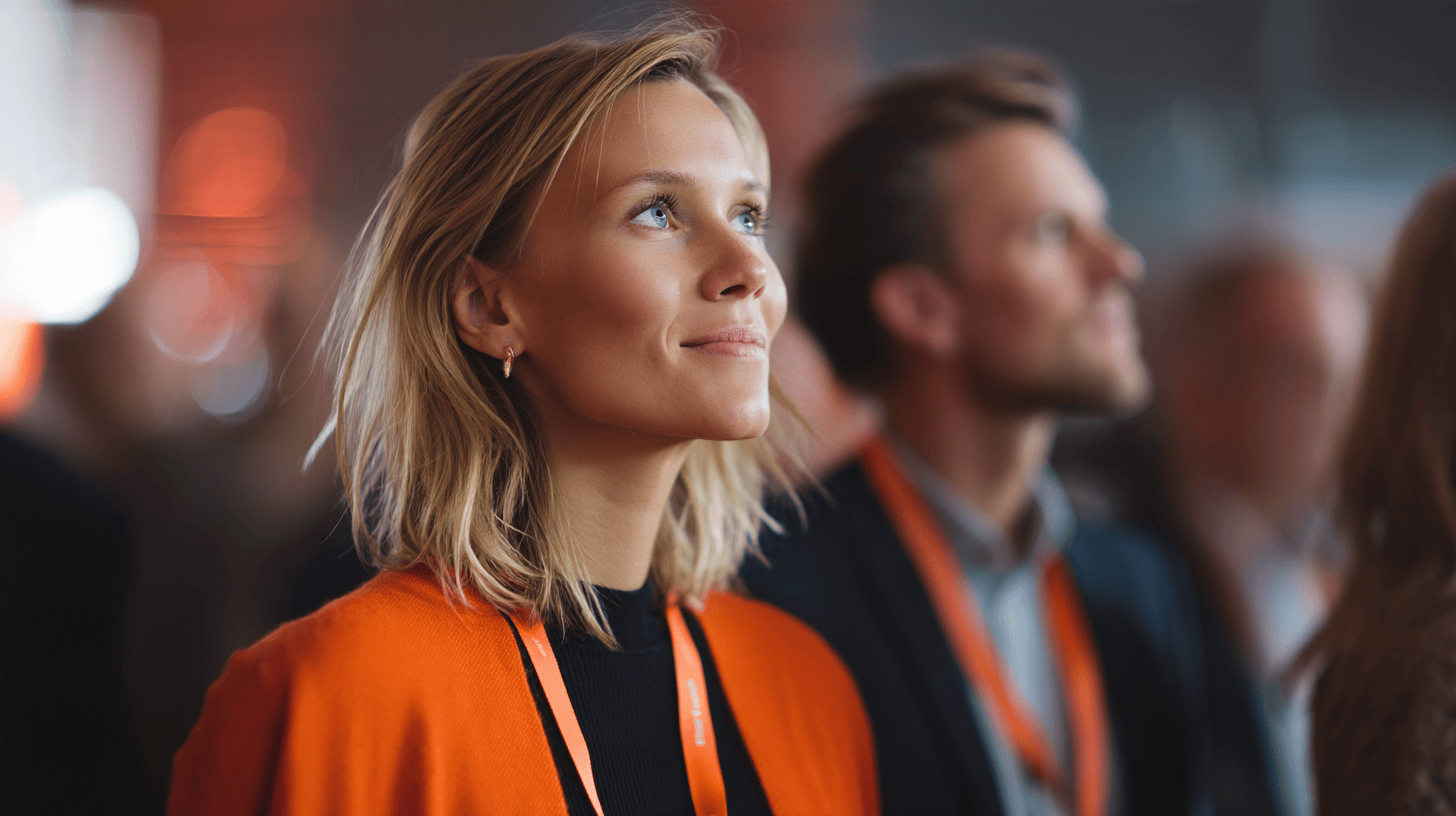 Woman in orange, focused expression.