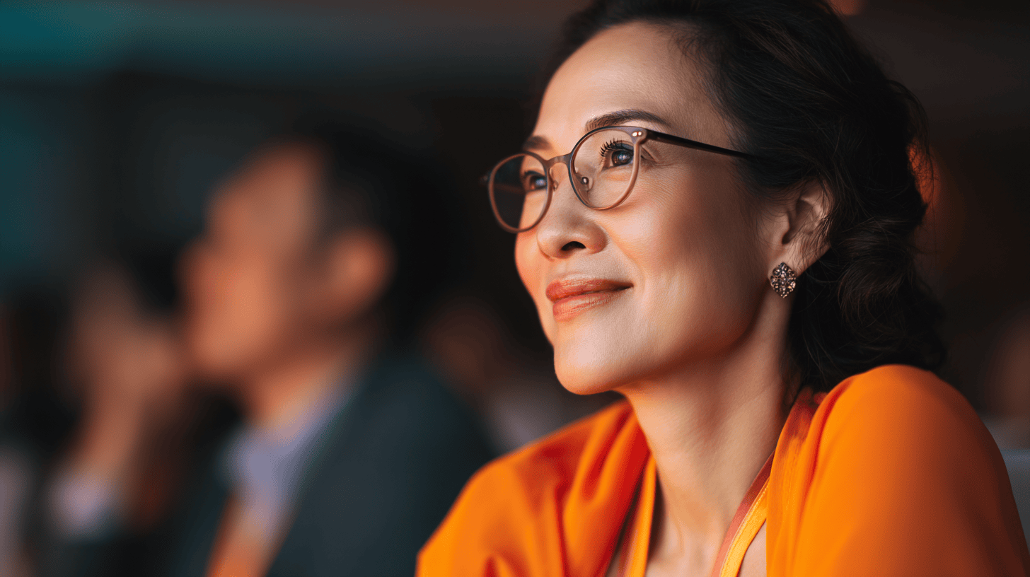 Woman smiling, engaged in conversation.