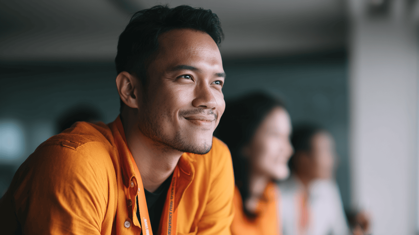 People in orange shirts observing something.