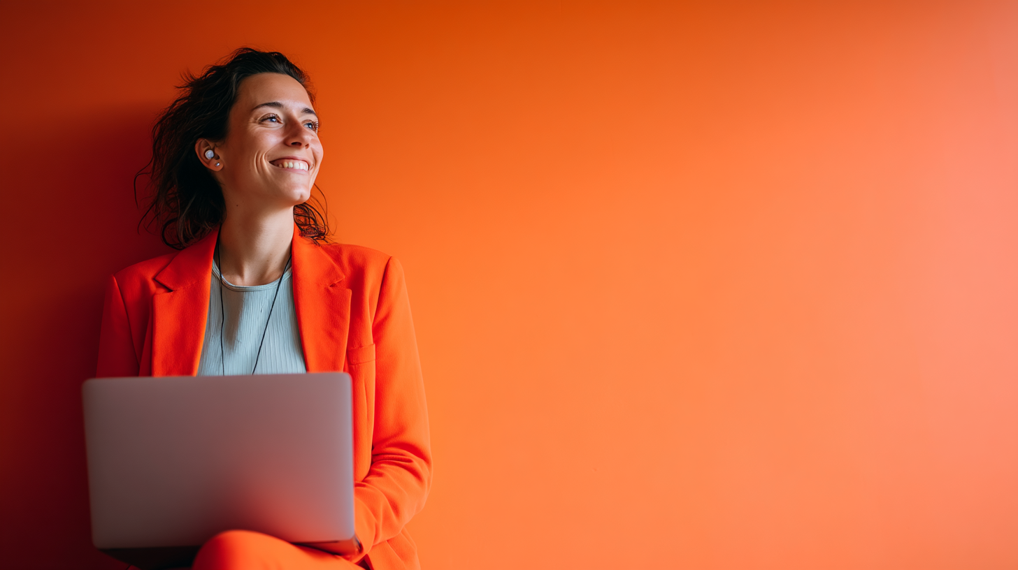 Person in orange suit using laptop.
