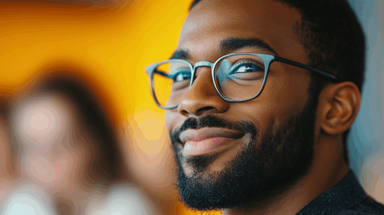 a man wearing glasses and smiling