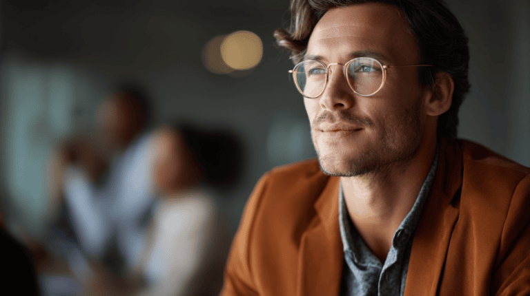 Man in brown jacket, thoughtful expression.