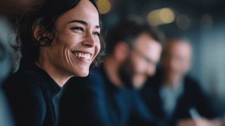Smiling woman in a meeting setting.